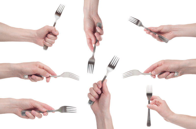 Multiple forks being held by hands