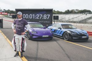 A pair of Porsches and a man at laguna seca.