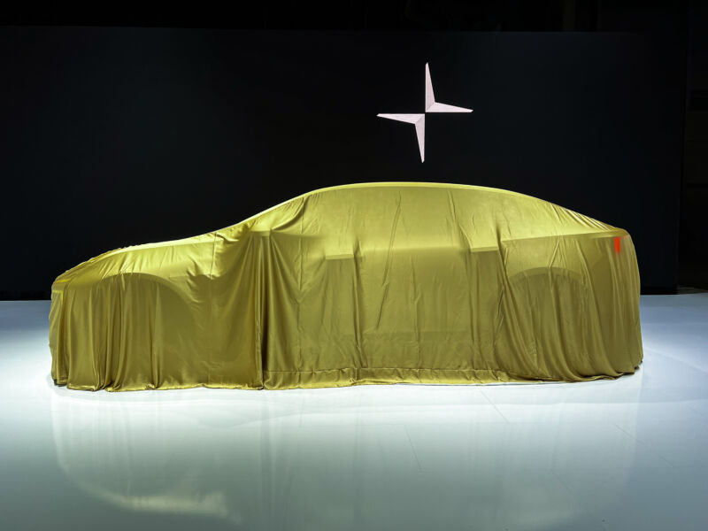 A car underneath a gold dustcloth