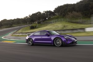 A purple Porsche Taycan on track