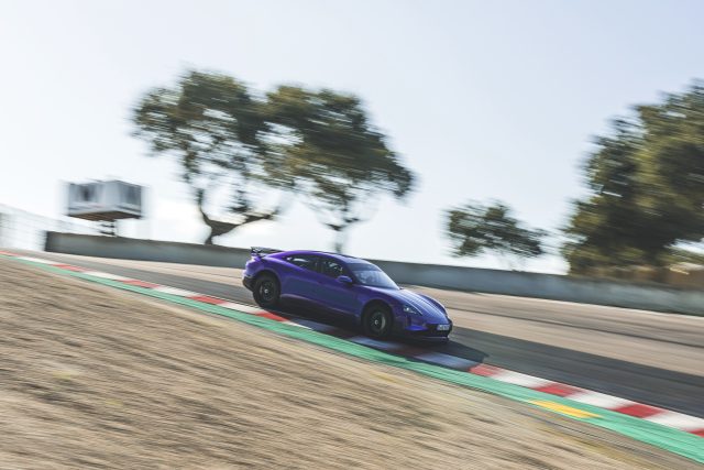 A porsche taycan negotiates the corkscrew at Laguna Seca