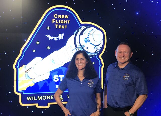 Suni Williams and Butch Wilmore, the two NASA astronauts training to fly on Starliner, pose with their mission patch at NASA's Johnson Space Center in Houston.