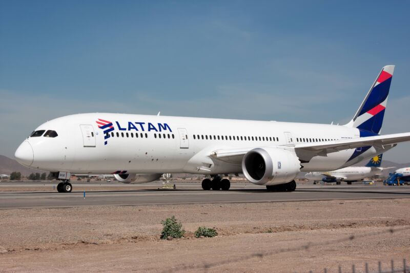 A Boeing airplane on a runway. The LATAM Airlines logo is printed on the side of the plane.