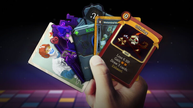 A hand holding a set of cards from popular roguelike deckbuilders, including Slay the Spire and Balatro