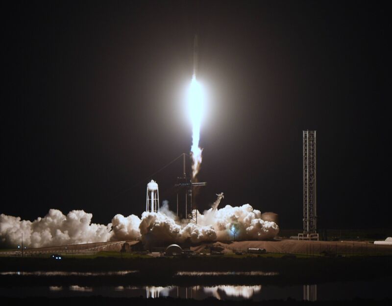 A SpaceX rocket lifting off the ground at the beginning of a launch