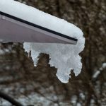 Snow and ice cover part of a Starlink satellite dish.