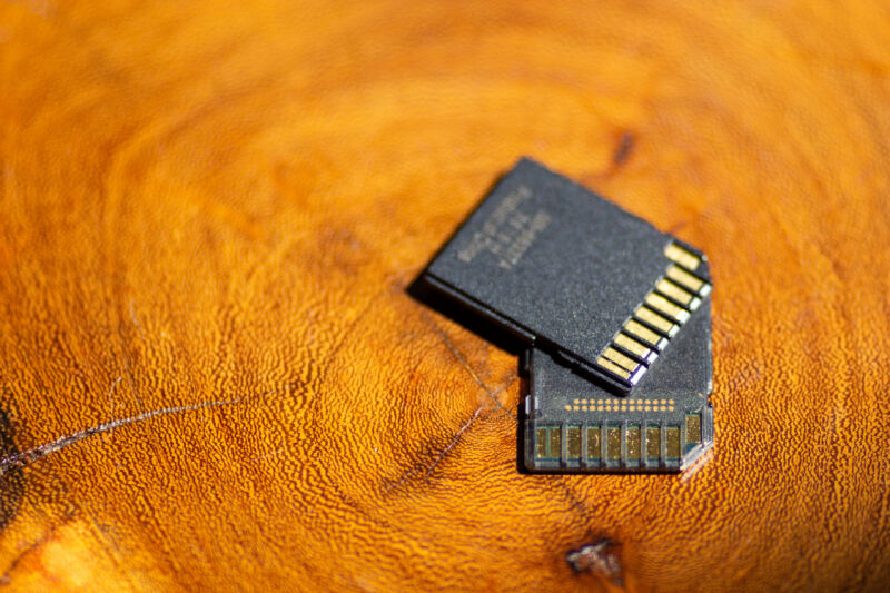 Two SD cards on a wood surface