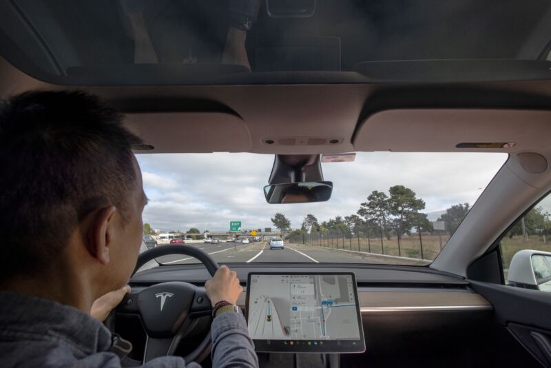 Tesla Model Y, equipped with FSD system. View of FSD system in action with Tesla dashboard display.