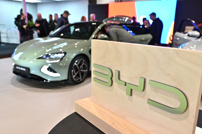 BYD logo branding is pictured in front of a BYD Seal fully electric EV car during the Everything Electric London 2024 at ExCel on March 28, 2024 in London, England.
