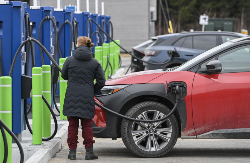 A driver charges an electric vehicle at an Electric Circuit fast-charging point at the La Porte de l'Erable rest area in Saint-Louis-de-Blandford, Quebec, Canada, on Monday, April 1, 2024. The charging point is the largest of its kind in Quebec and can charge 24 electric vehicles simultaneously.
