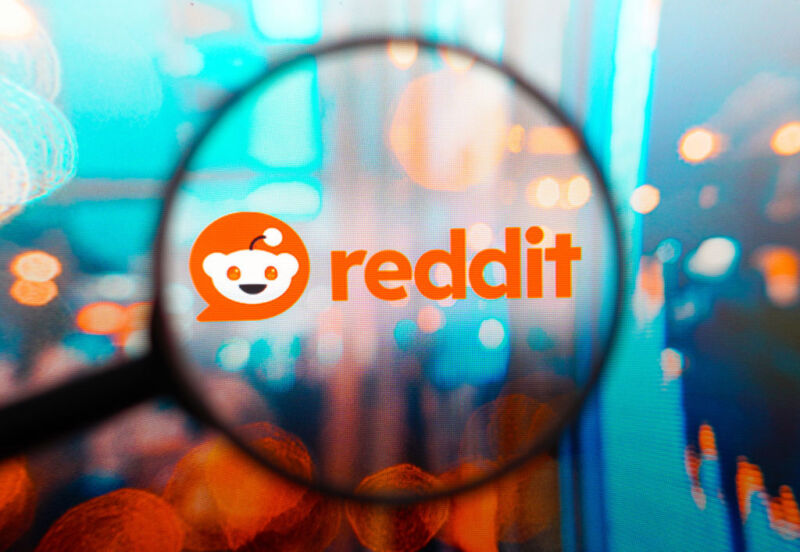 BRAZIL - 2024/04/08: In this photo illustration, a Reddit logo seen displayed on a computer screen through a magnifying glass