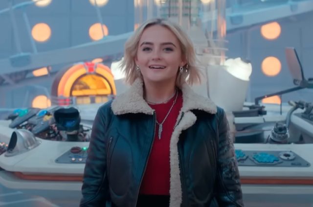 cheerful young blond woman standing in the TARDIS