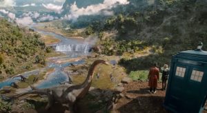 The Doctor and Ruby in right of frame looking at dinosaurs in their natural Jurassic habitat