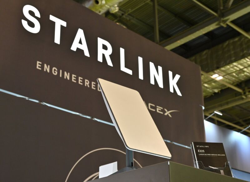 A Starlink terminal in front of a sign that says, 