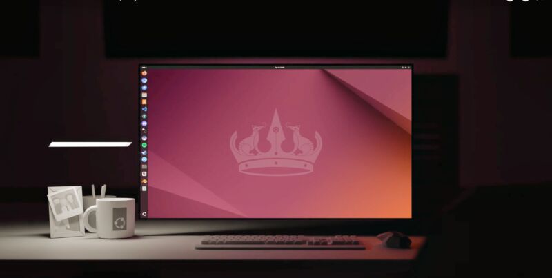 Escritorio Ubuntu ejecutándose en una computadora portátil en un escritorio renderizado en 3D, con una taza de café poligonal blanca y un marco de fotos cerca.