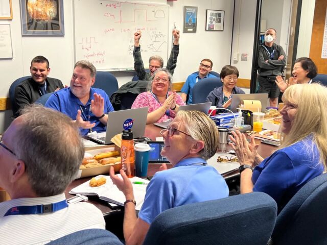 Voyager 1's team celebrates the arrival of a radio signal from the spacecraft Saturday.