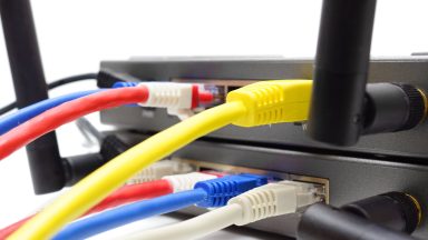 Ethernet cables connected to the ports in a wireless router