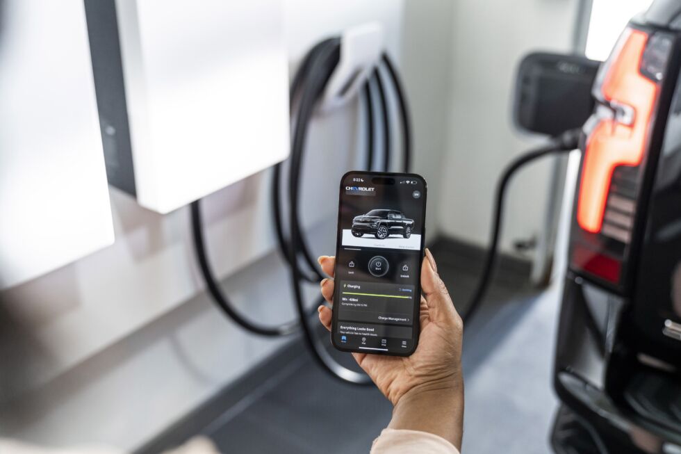 MyChevrolet mobile app displaying charging status of 2024 Chevrolet Silverado EV RST in a residential garage with GM Energy products.