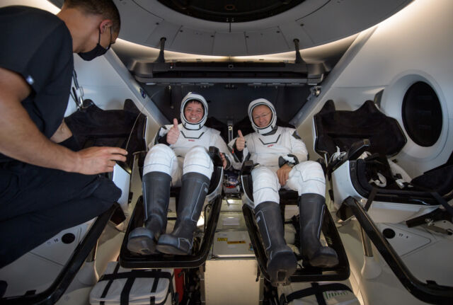 Astronauts Bob Behnken and Doug Hurley inside SpaceX's Crew Dragon spacecraft after splashdown to conclude the Demo-2 mission in August 2020.