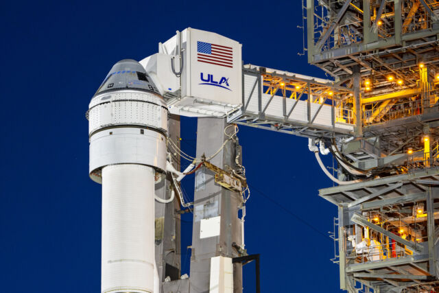The crew access arm is seen extended into position next to the Starliner spacecraft on its launch pad at Cape Canaveral Space Force Station, Florida.