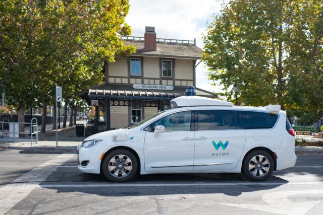 A Waymo self-driving minivan, with safety driver visible, in 2018. 