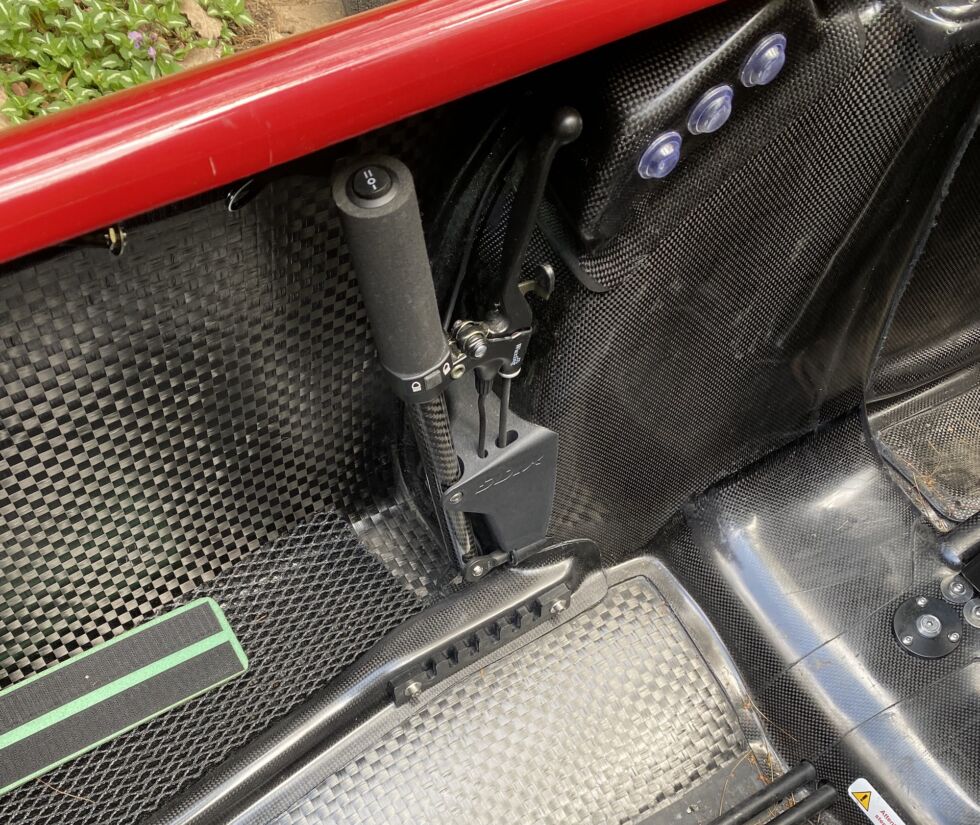 The steering machinery and brake lever tucks in underneath the aero shell. There's a matching lever on the opposite side.