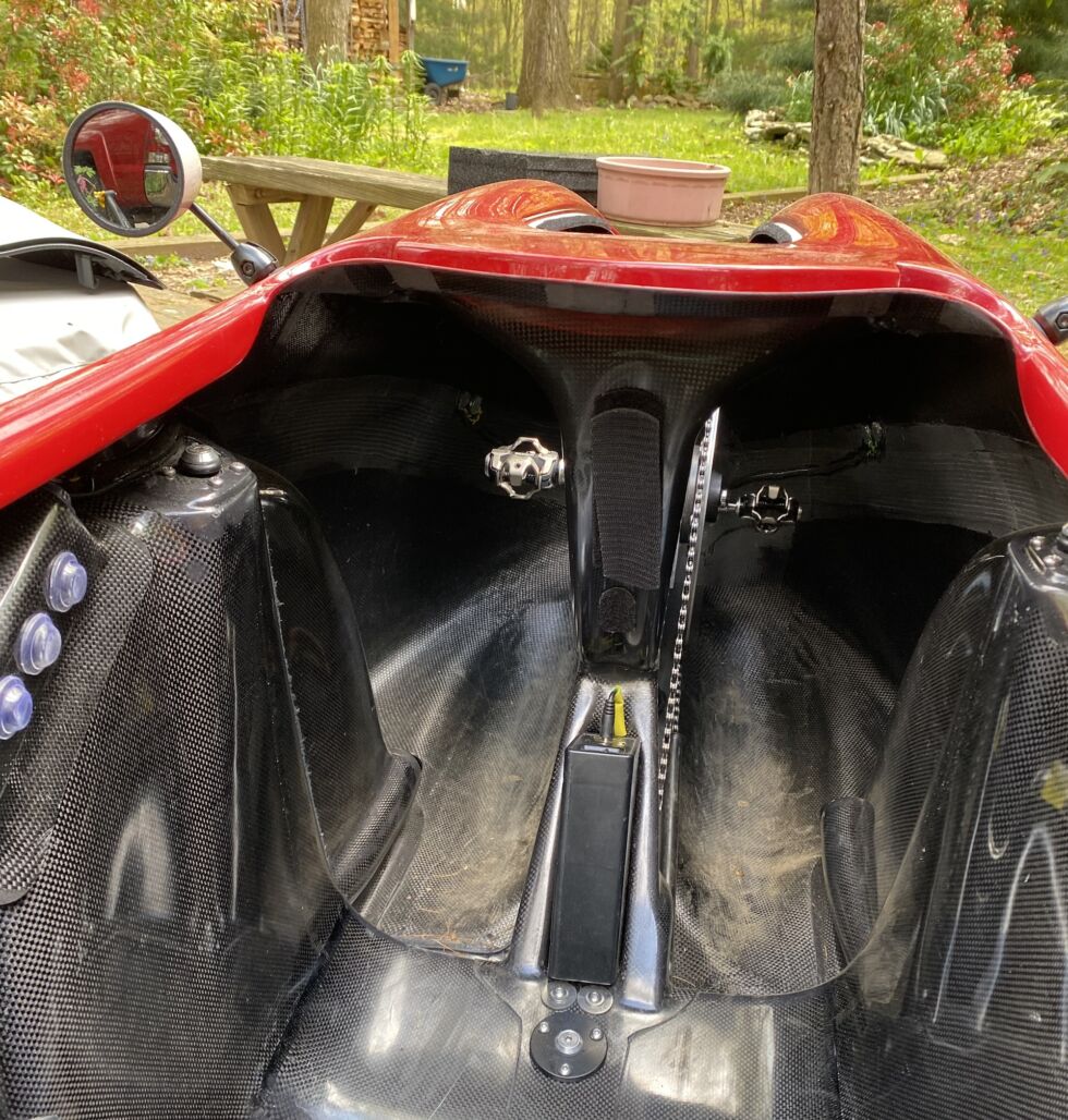 Looking forward from the seat, switches for the lights are on the left, the cranks are in front, and the battery to power the electrics is in the foreground. Above the battery is a vent to allow airflow over the rider, but it was covered by a velcro patch since the weather was cool.