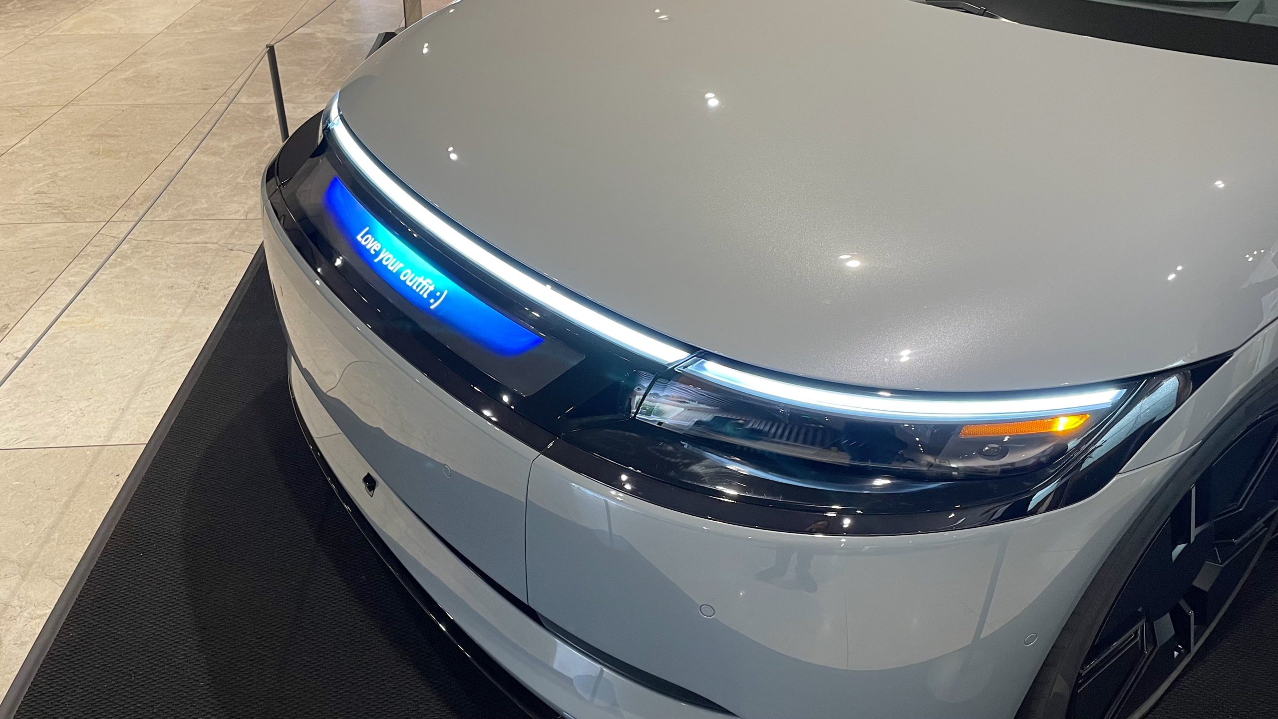 A message displayed on the nose of the AFEELA ev that says "Love your outfit :)"