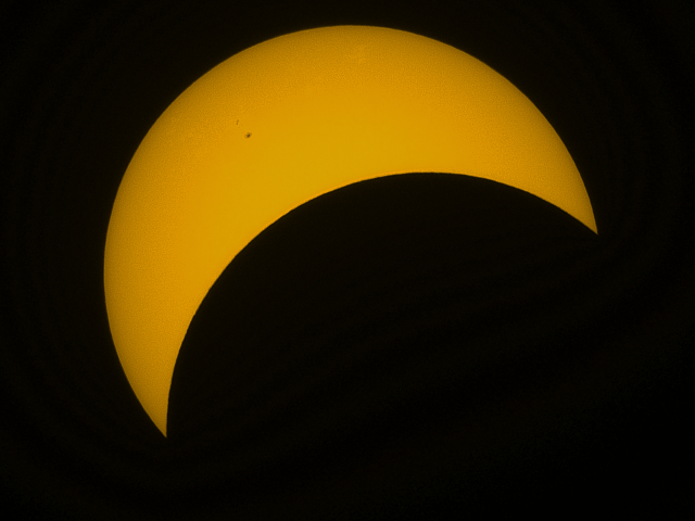 The moon moves in front of a vibrant sun