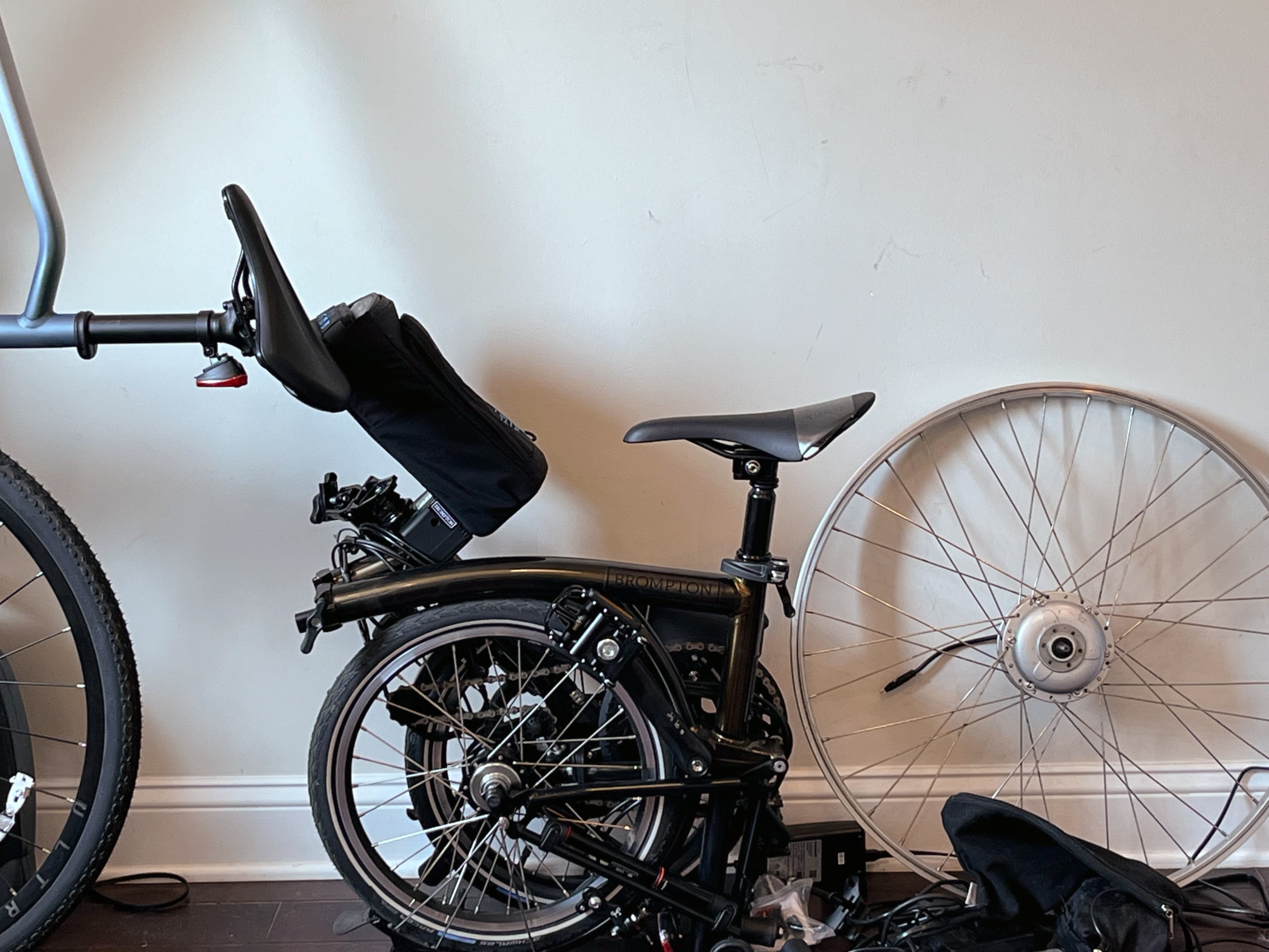 The Brompton C Line, fully folded, with vertical Velotric and 700c hub wheel for reference.