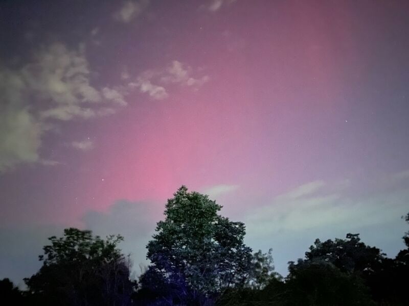 Pink lights appear in the sky above College Station, Texas.