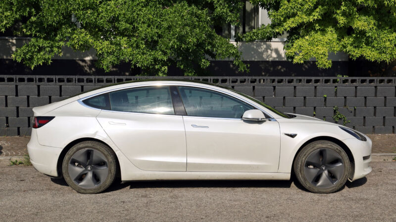 A white Tesla Model 3 in slightly used condition