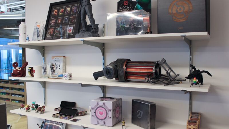 Shelves at Valve's offices, as seen in 2018, with a mixture of artifacts from Half-Life, Portal, Dota 2, and other games.