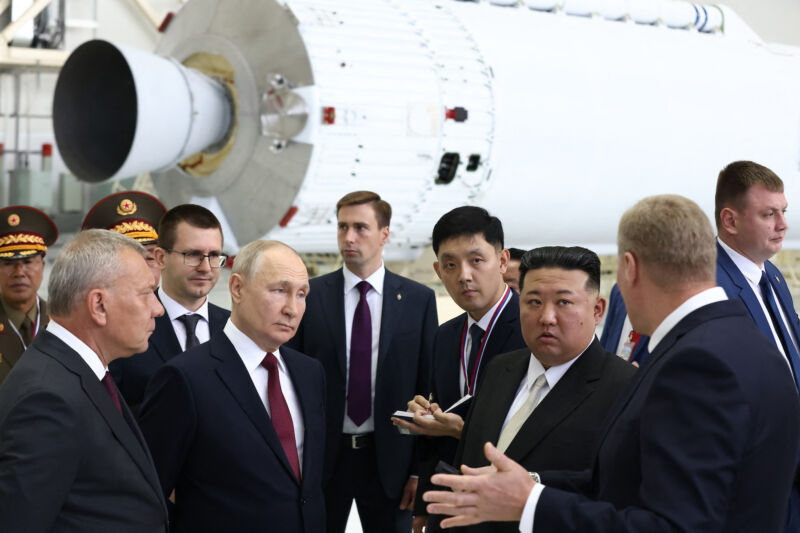 In this pool photo distributed by Sputnik agency, Russia's President Vladimir Putin and North Korea's leader Kim Jong Un visit the Vostochny Cosmodrome in Amur region in 2023. An RD-191 engine is visible in the background.