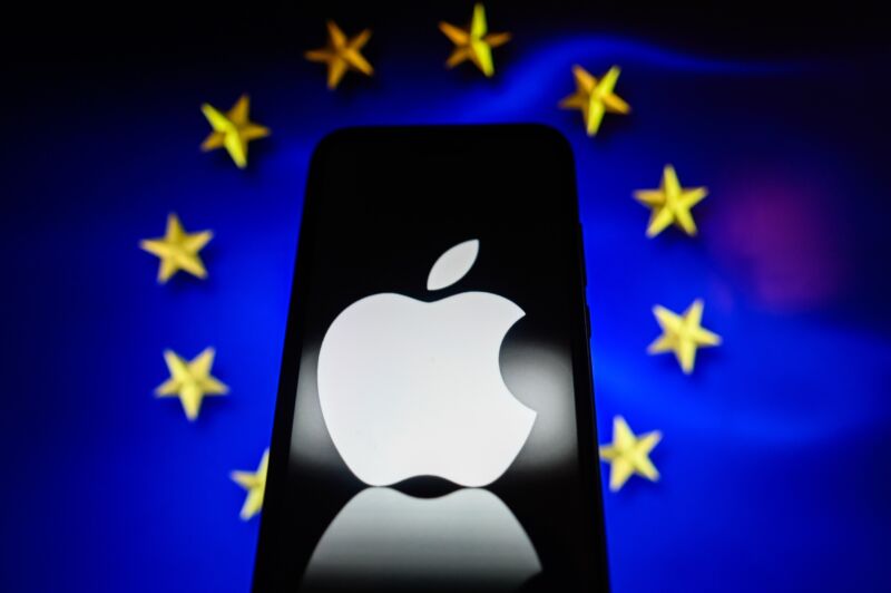 Apple logo is displayed on a smartphone with a European Union flag in the background.