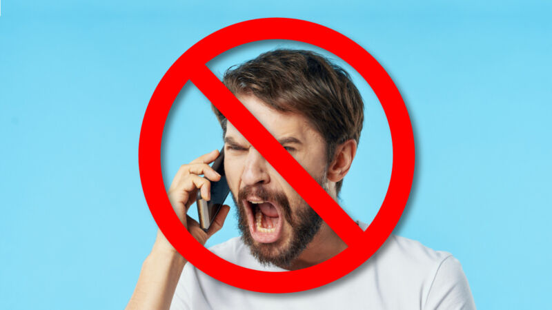 A man is angry and screaming while talking on a smartphone.