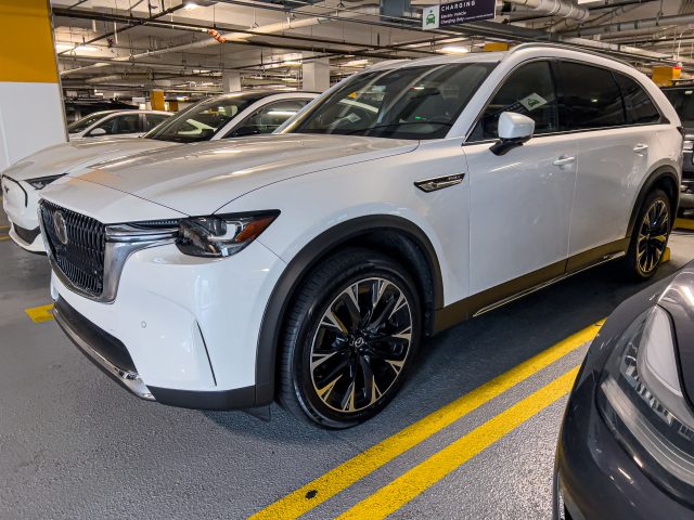 A white Mazda CX-90 in an underground parking lot