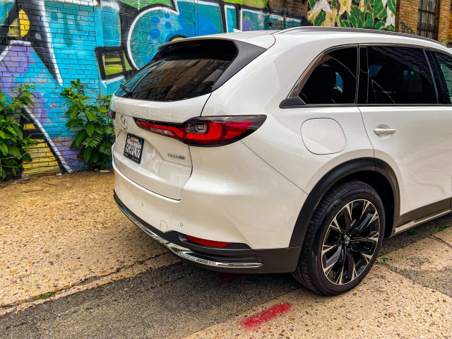 A white Mazda CX-90 SUV in an alley