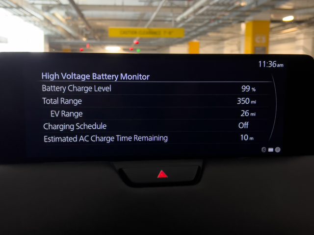 Mazda CX-90 PHEV infotainment screen showing charging status. The battery is at 99 percent and needs another 10 min to get to 100