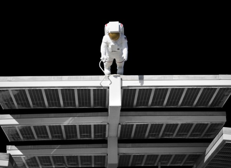 Artist's depiction of an astronaut servicing solar panels against the black background of space.