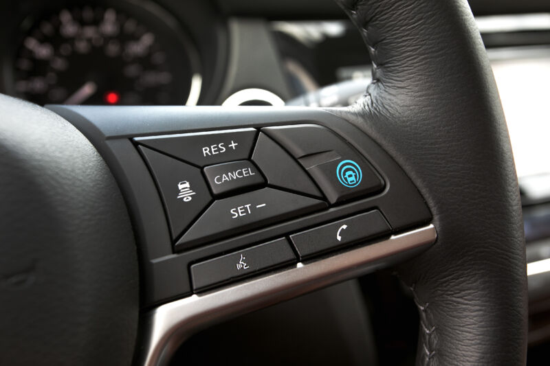 A Nissan steering wheel with ProPILOT assist buttons on it