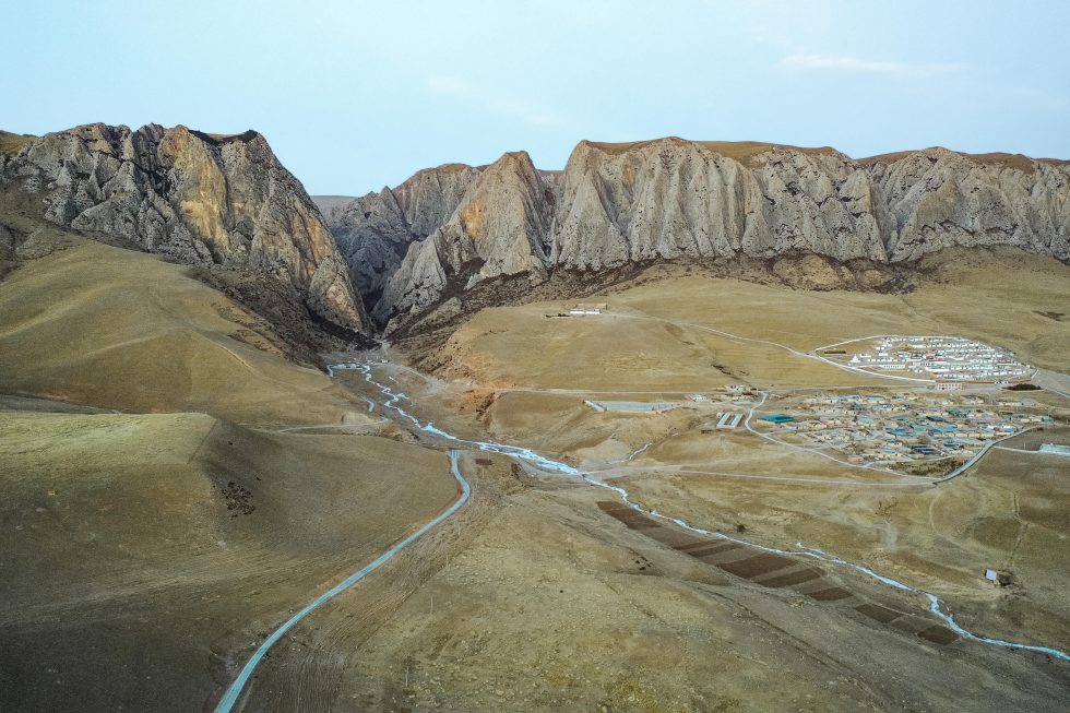 The Gangjia Basin is bordered by cliffs containing the Baishia karst cave.