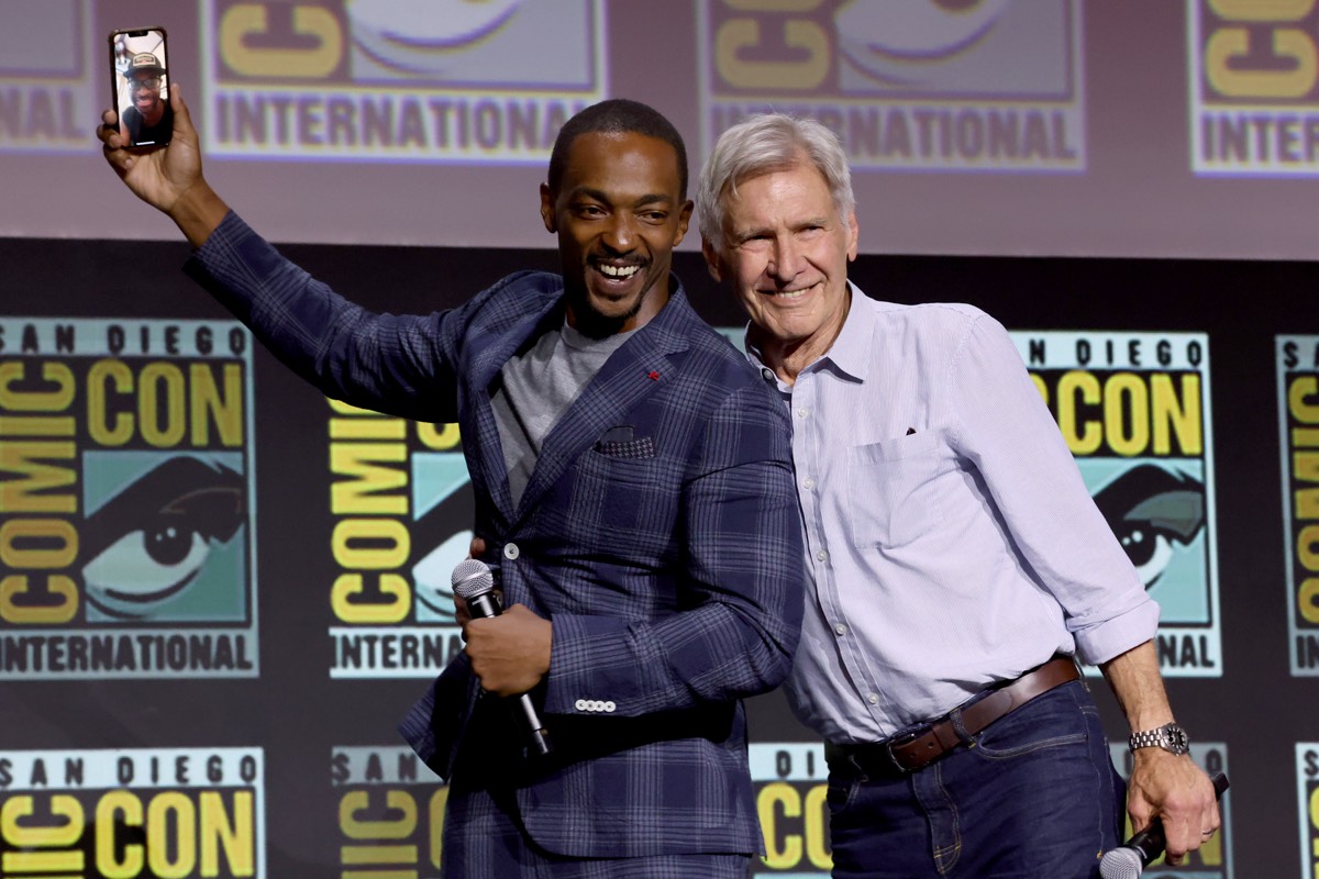 Anthony Mackie and Harrison Ford strike a pose onstage during the Marvel panel at San Diego Comic-Con.