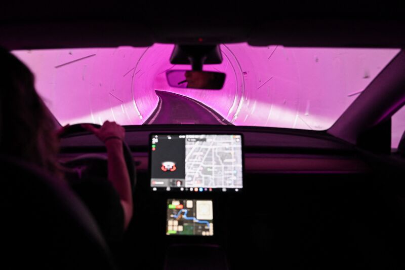 A Tesla Inc. electric vehicle is driven through a tunnel in the Boring Company's Las Vegas Convention Center Loop during the Consumer Electronics Show (CES) in Las Vegas, Nevada, on January 5, 2023.