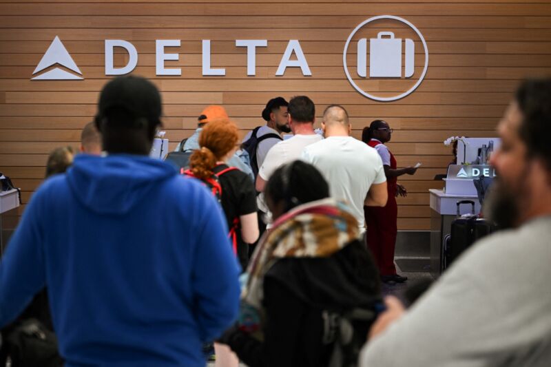 Passengers at Delta Air Lines contemplating missing luggage in an airport baggage claim area.