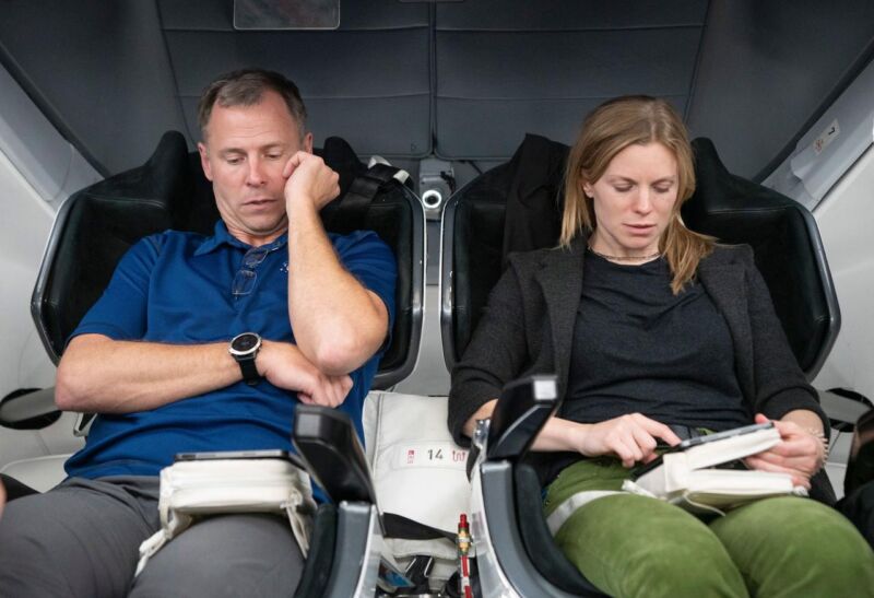 Nick Hague, left, and Zena Cardman train inside a Crew Dragon spacecraft mock-up in November 2023.