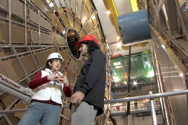 Physicist David Kaplan interviews Fabiola Gianotti, head of one of the two teams that found the Higgs Boson at CERN, in a still from <em>Particle Fever</em>.