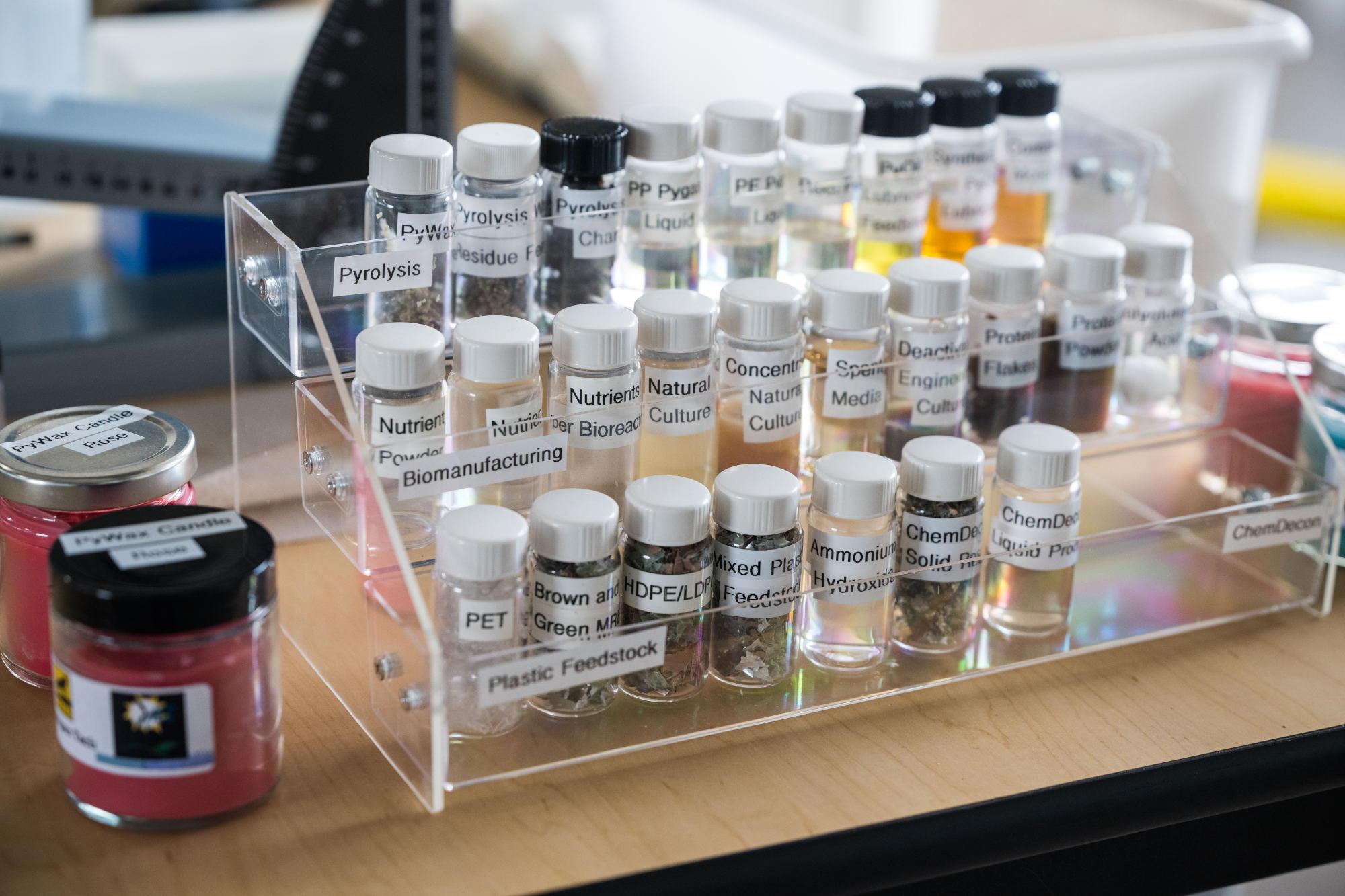 Materials for the MTU project are shown at a recent demonstration. Before being placed in a reactor, plastic feedstocks (bottom row) are mechanically shredded into small pieces.