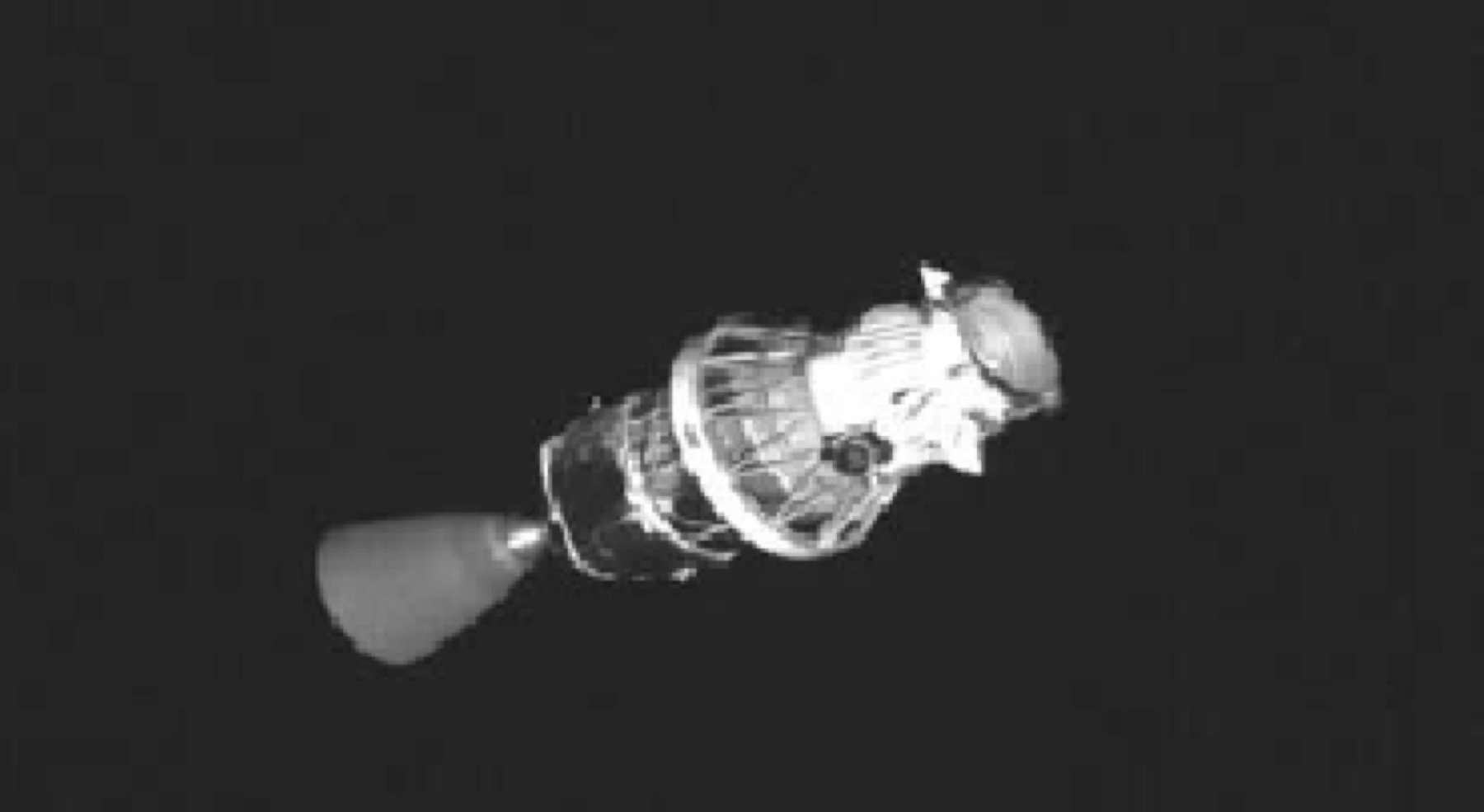 A black and white image of the upper stage of a Boeing Delta II rocket, taken by the Air Force Research Laboratory's XSS-10 satellite in 2003.