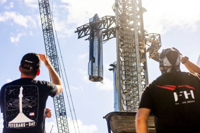 SpaceX hoists the Starship upper stage atop a Super Heavy booster at the company's launch site in South Texas.